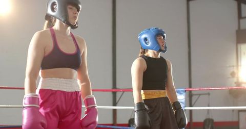 Female Boxers Sparring in Ring Under Bright Gym Lights, Women's Amateur Boxing Match