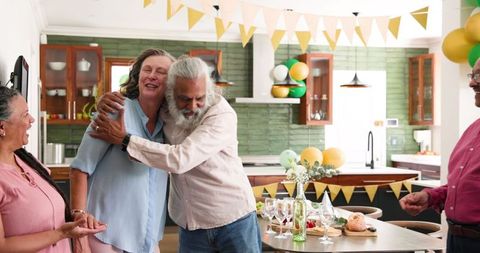 Diverse Senior Friends Embracing at Celebration Gathering