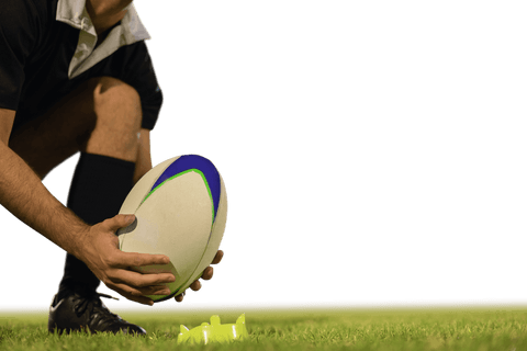 Transparent rugby player setting ball on kicking tee at night