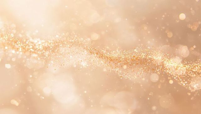 Shimmering golden glitter wave flowing across warm peach bokeh background for luxury decor