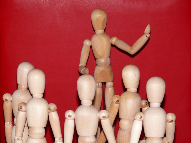 Leader Mannequin Demonstrating to Group on Red Background - Download Free Stock Images Pikwizard.com