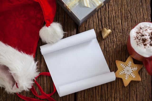 Blank paper with santa hat on a plank