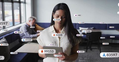 Businesswoman using tablet with augmented reality notifications in coworking lounge