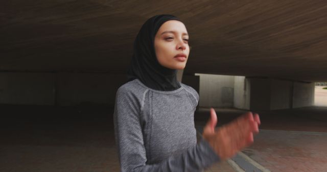 Focused Woman in Hijab Preparing for Outdoor Run - Download Free Stock Images Pikwizard.com