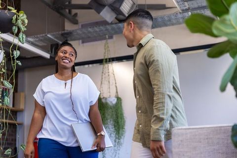 Diverse Coworkers Collaborating in a Modern Sustainable Office