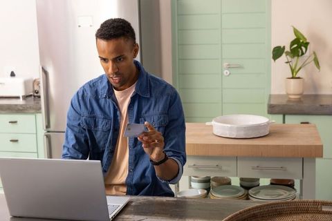 Man Shopping Online in Contemporary Kitchen