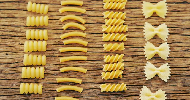 Assorted Uncooked Pasta on Rustic Wooden Surface in Rows - Download Free Stock Images Pikwizard.com