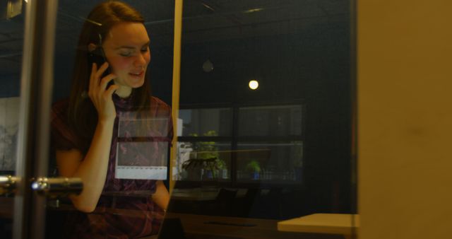 Businesswoman speaking on phone in office cubicle - Download Free Stock Images Pikwizard.com