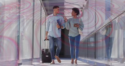 Business Travelers Walking Through Modern Airport Corridor with Luggage