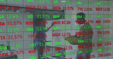 Coworkers collaborating over analytics board with stock tickers reflected on glass wall