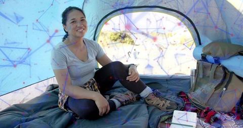 Happy Camper Enjoying Mountain Adventure in Tent