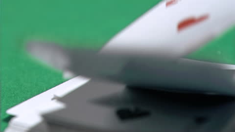 Slow Motion Playing Cards Falling on Green Poker Table