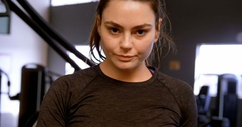 Confident woman in fitness studio focused on workout