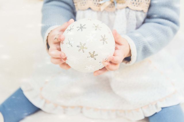 Child Holding Christmas Ornament in Winter Light - Download Free Stock Images Pikwizard.com