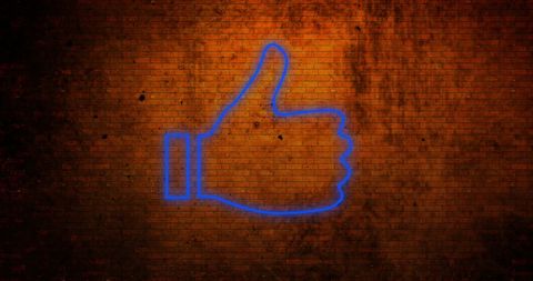 Thumbs Up Neon Symbol Against Brick Wall