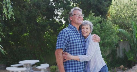 Joyful Senior Couple Embracing in Lush Backyard - Download Free Stock Images Pikwizard.com