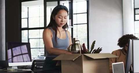 Young professionals unpacking in modern office environment