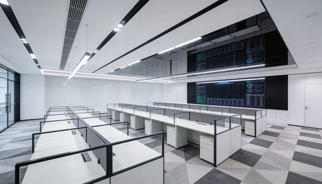 Modular workstations featuring glass dividers and pedestals in minimalist open-plan office
