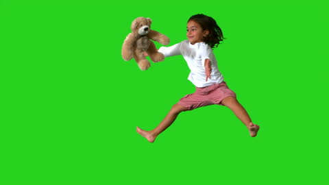 Joyful Little Girl Jumping with Teddy Bear, Green Screen Background