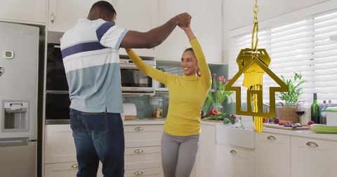 Happy Couple Celebrates New Home with Dance in Kitchen