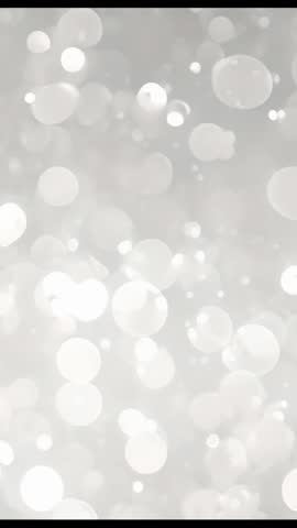 Vertical Bokeh Light Drift Looping Video, Soft Gray Sparkling Circles for Social Stories