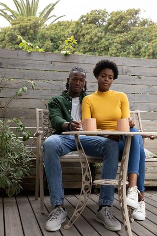 Serene African American Couple Relaxing Outdoors with Coffee