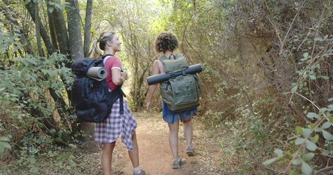Two women hiking trail experience nature adventure