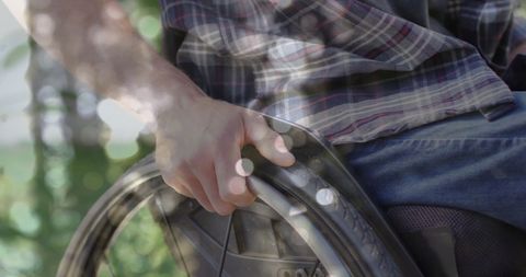 Person Using Wheelchair Outdoors With Sunny Reflection