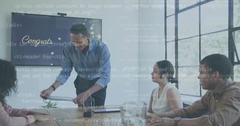 Corporate celebration handing award document to colleagues in bright modern boardroom