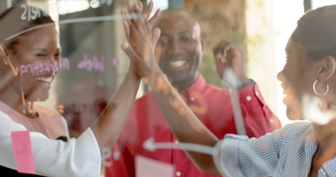African American Colleagues Celebrating Success at Office Meeting