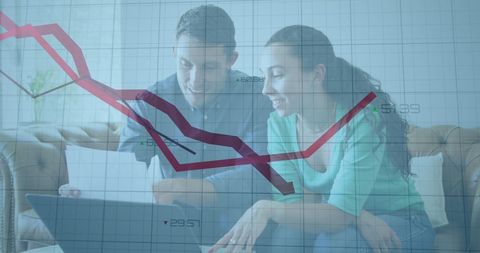 Smiling couple analyzing graph data on laptop screen