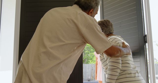 Elderly Couple Embracing in Doorway for Support and Care - Download Free Stock Images Pikwizard.com