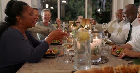 Senior Diverse Friends Toasting at Wedding Celebration Dinner