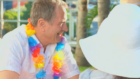 Man Enjoying Sunny Beach Vacation with Flower Lei