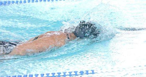 Competitive Swimmer Gliding Through Pool Water with Streamlined Grace - Download Free Stock Images Pikwizard.com