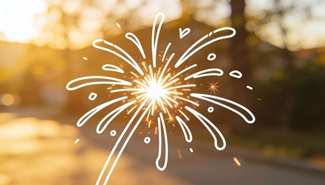 Handheld sparkler sparking at sunset casting warm bokeh with white doodle firework overlay