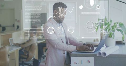 Entrepreneur working on laptop at coworking counter with hud analytics and blueprints