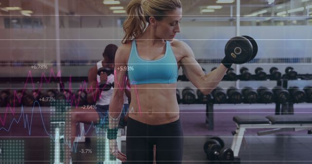 Fit woman lifting dumbbell in modern gym with futuristic data overlay - Download Free Stock Images Pikwizard.com