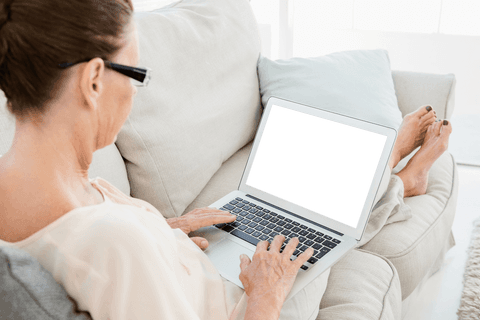 Woman Relaxing on Sofa with Transparent Laptop Screen for Mockups - Download Free Stock Videos Pikwizard.com
