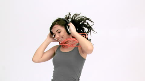 Joyful Brunette Enjoying Music in Motion with Headphones