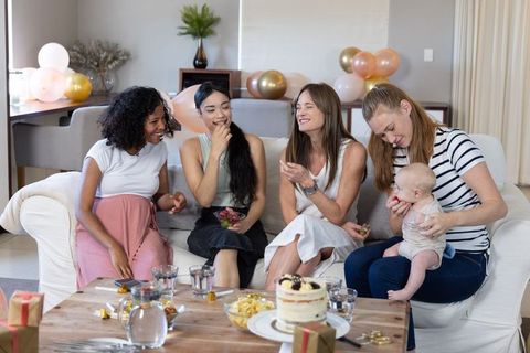 Diverse Female Friends Enjoying Baby Shower in Cozy Living Room