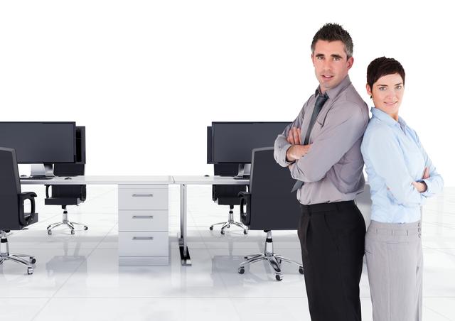 Digital composite image of male and female executive standing back to back with arms crossed in office