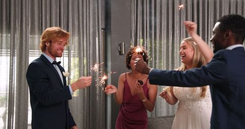 Joyful Wedding Celebration with Multiracial Friends Holding Sparklers