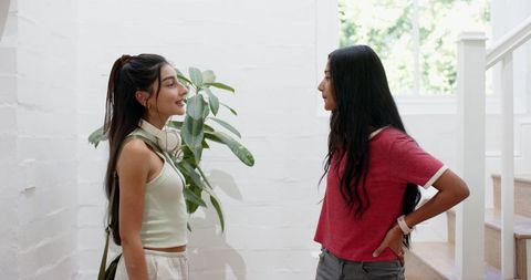 Two Friends Chatting in Bright Modern Hallway
