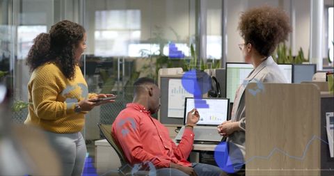 Diverse Team Analyzing Data with Digital Financial Graphs in Modern Office