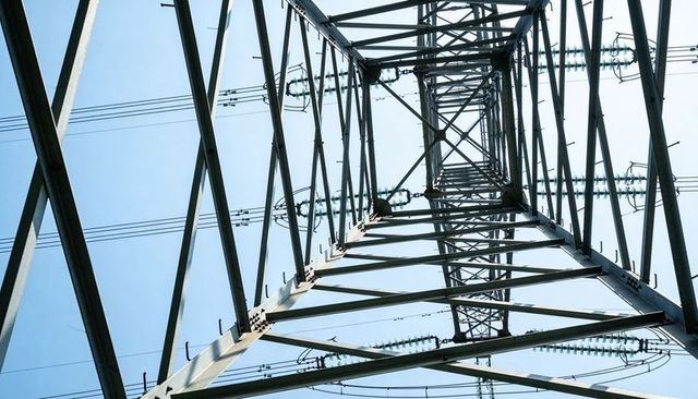 Rising steel transmission tower lattice with diagonal beams, insulators and conductor lines