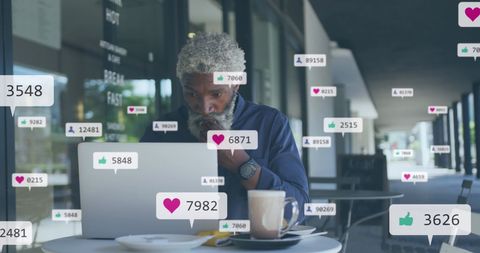 African American Man Engaged with Social Media on Laptop