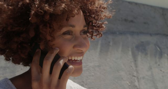 Smiling Woman with Curly Hair Talking on Phone Outside - Download Free Stock Images Pikwizard.com