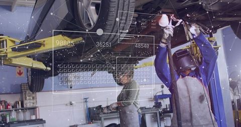 Female mechanic tightening undercarriage wearing welding helmet with digital hud overlay