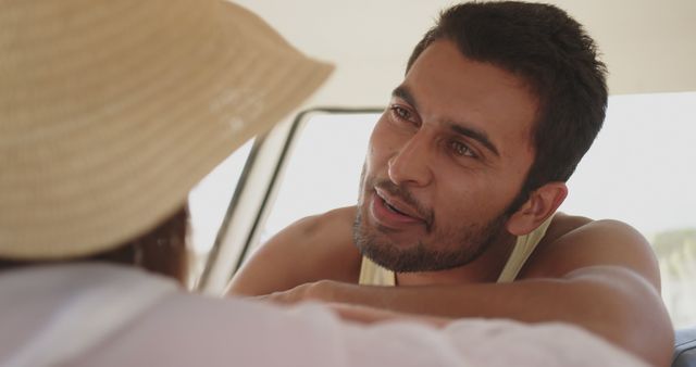 Man Relaxing on Vacation and Smiling at Companion Under Hat - Download Free Stock Images Pikwizard.com